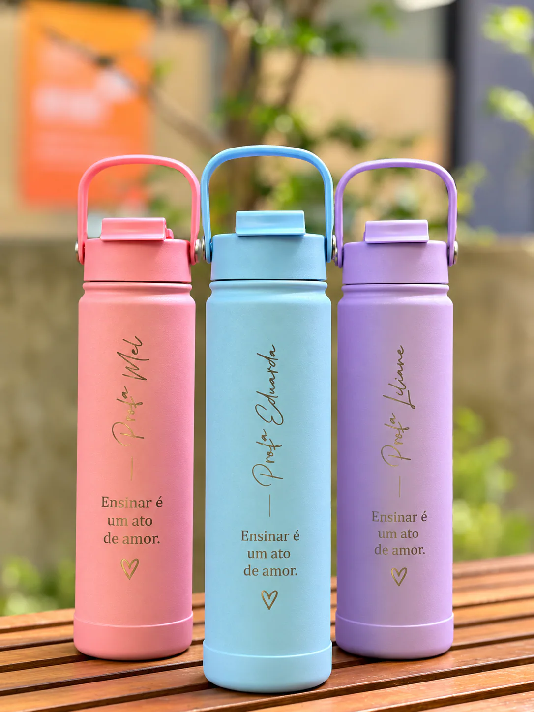Three personalized bottles in pink, blue and lilac