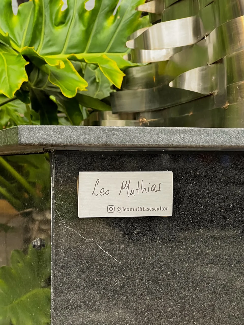 Detalhe da placa que identifica o escultor Leo Mathias na obra Vésta.