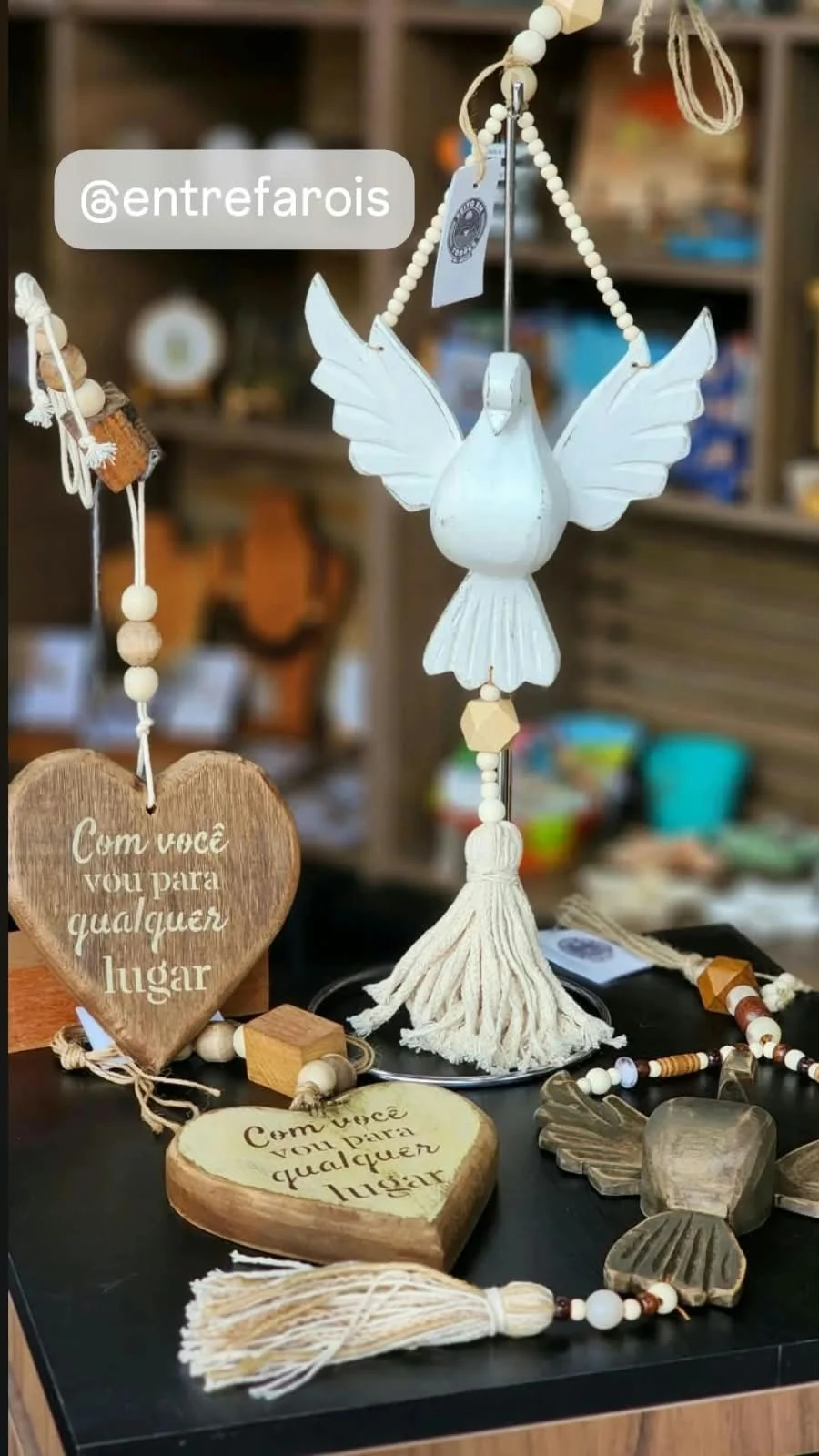 White dove, wooden hearts and ornaments with beads and tassels displayed in the shop.