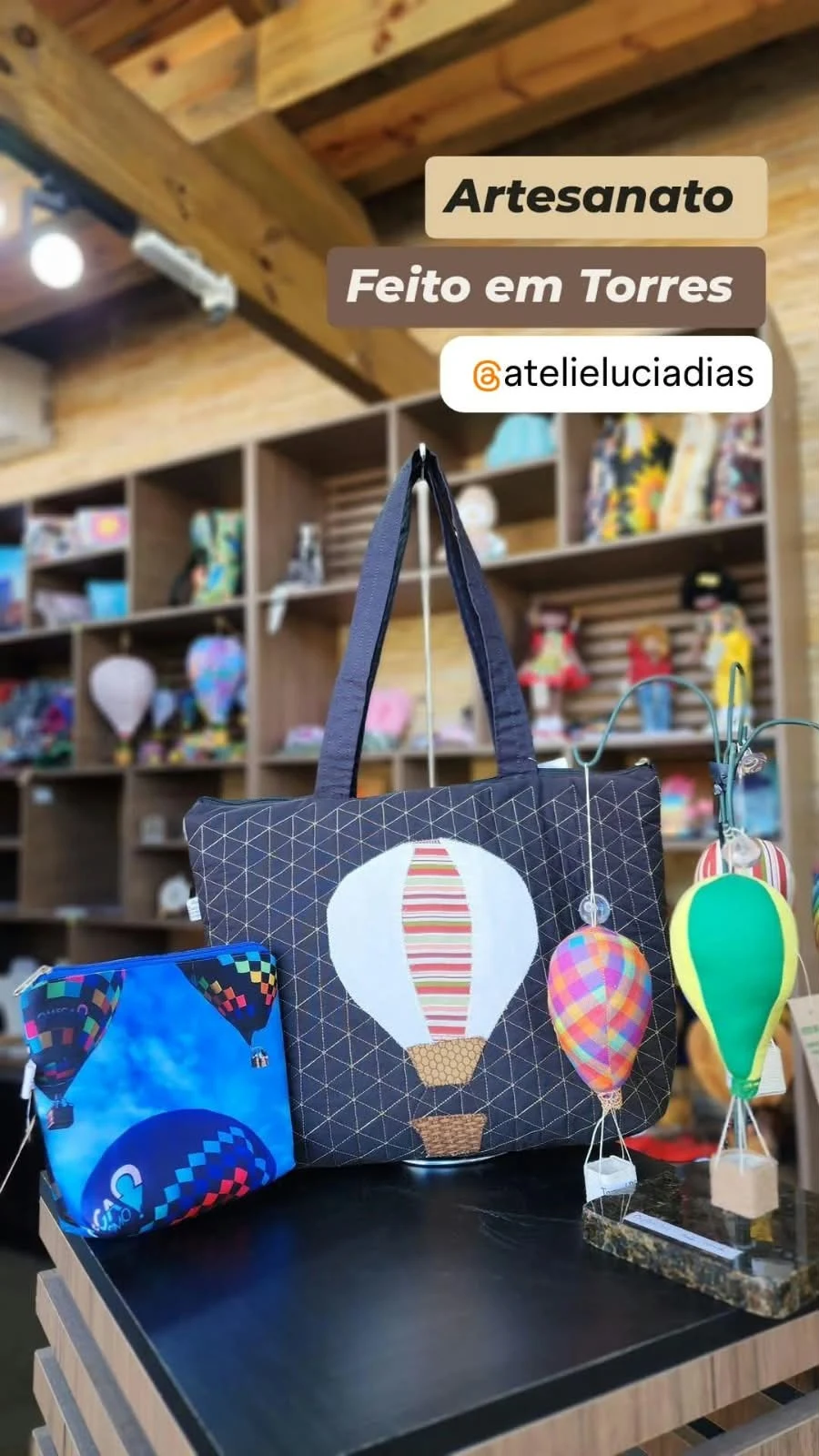 Fabric tote bag and pouch with hot-air balloon motifs, beside small decorative balloons.
